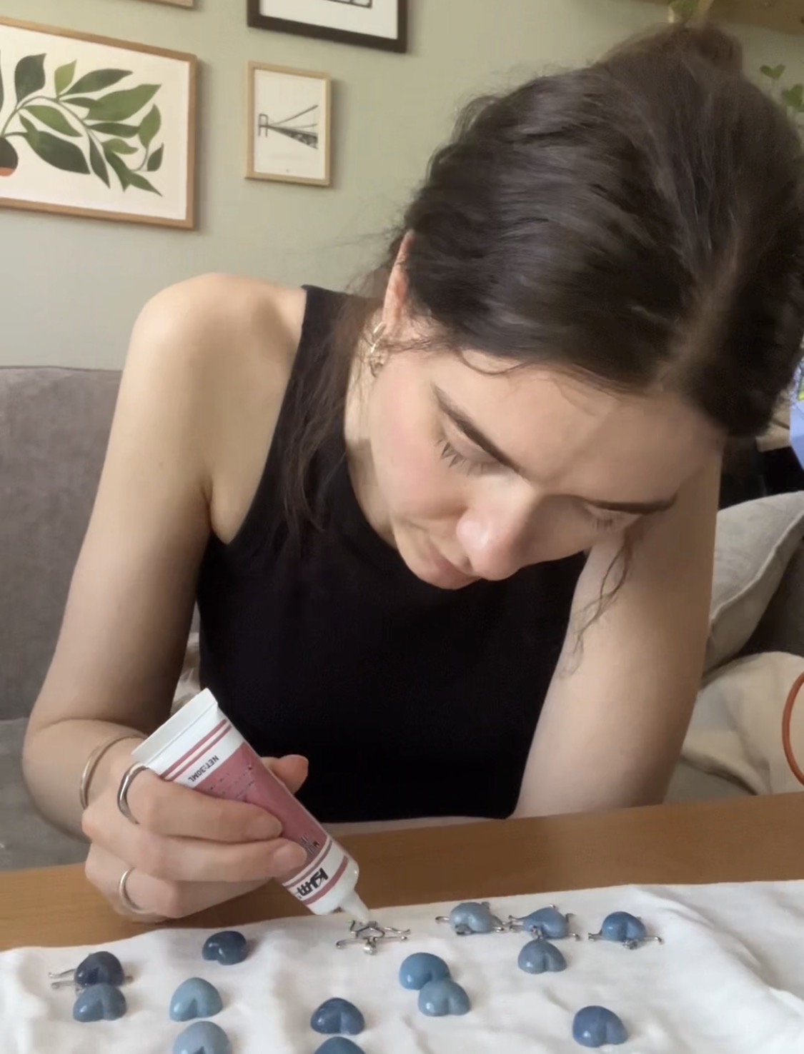 Eve setting the cut blue stones into pendants by hand